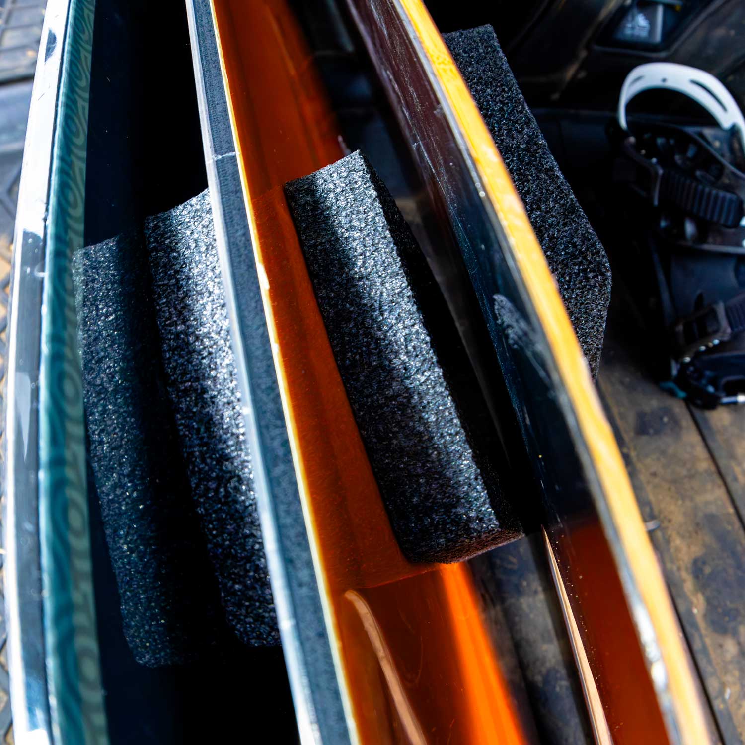 Snowboard edges with foam spacers packed inside travel bag