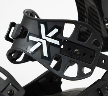Black snowboard binding highback with white X logo, close-up angle