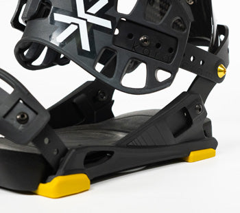 Black snowboard binding with yellow highlights, close-up angled view