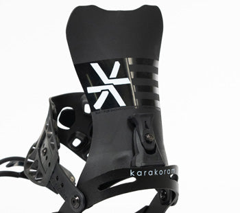 Black splitboard binding highback with straps, close-up studio shot