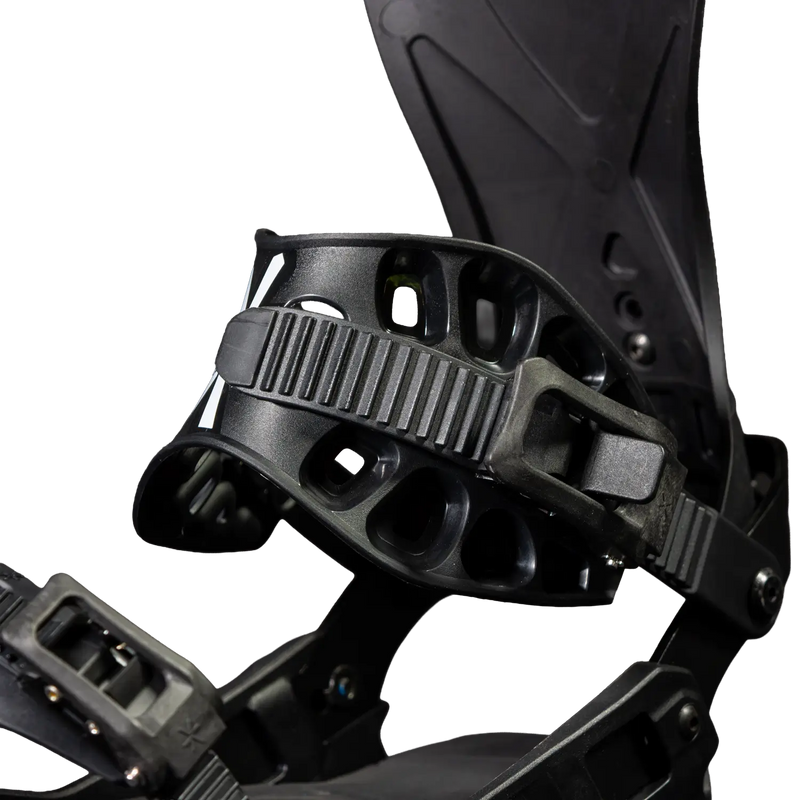 Close-up of black snowboard binding with ankle strap and highback