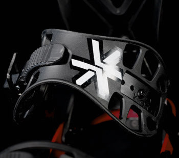 Black snowboard binding highback with white X logo, close-up angle