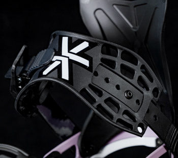 Close-up of black snowboard binding strap with white logo detail