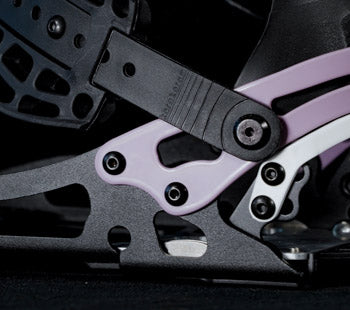Close-up of black and purple snowboard binding ratchet buckle mechanism