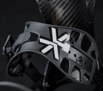 Black snowboard binding highback with white logo, close-up angle