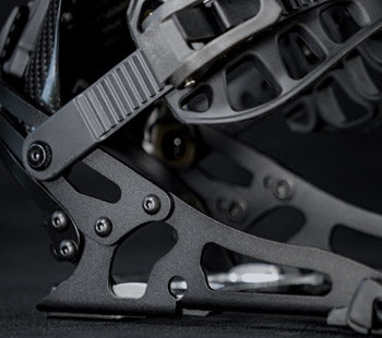Close-up of black compound bow riser with cutout aluminum limb pockets
