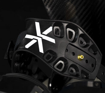 Black snowboard binding highback with white X logo, close-up