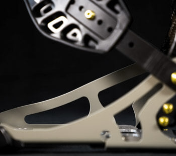 Close-up of drum pedal footboard with black plate and gold hardware