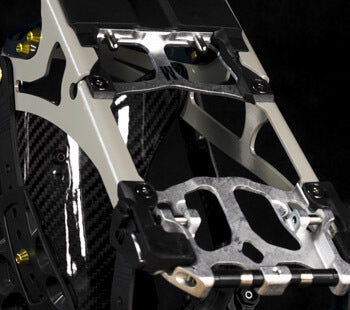 Close-up of aluminum cutout footpegs on carbon fiber motorcycle frame
