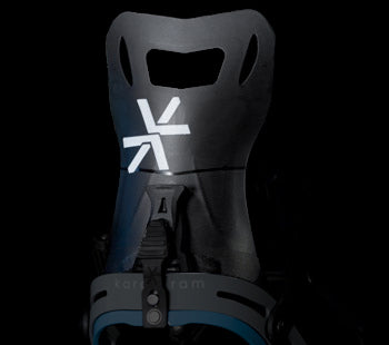 Black snowboard binding highback with white logo, close-up front view