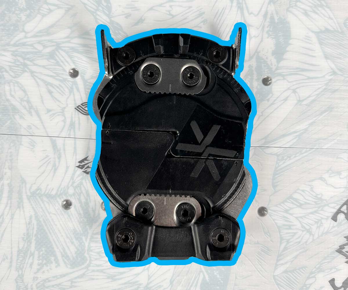 Black snowboard binding baseplate with adjustment discs and mounting screws