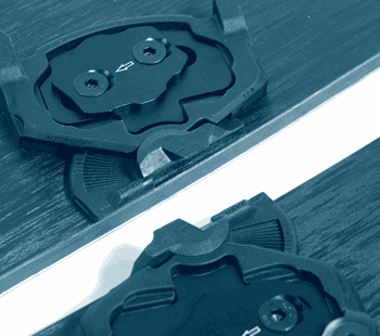 Close-up of ski boot binding mounts on wooden skis, blue tint