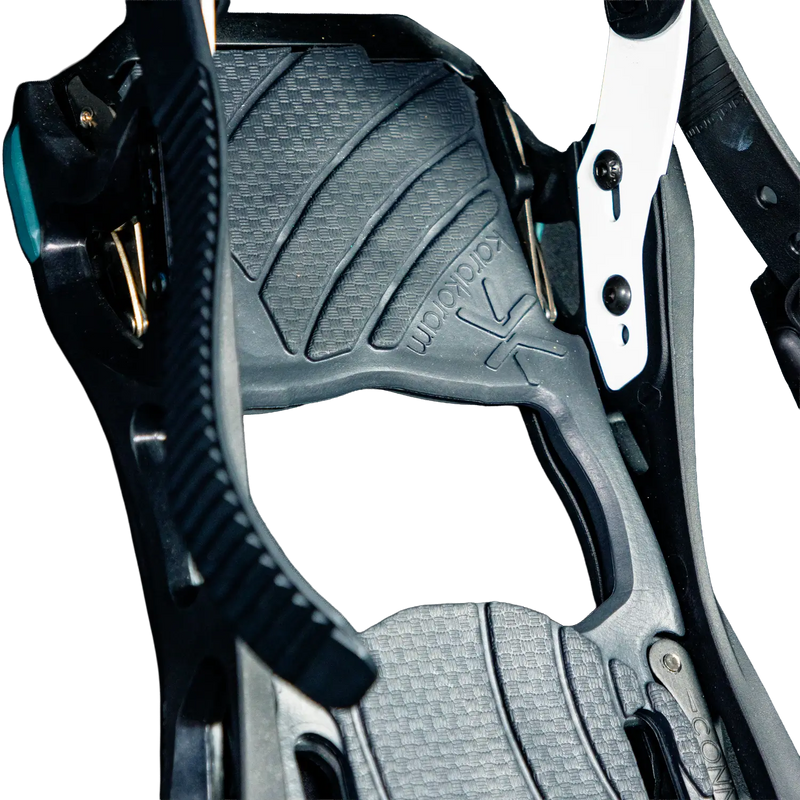 Close-up of black snowboard binding highback with textured footpad and straps
