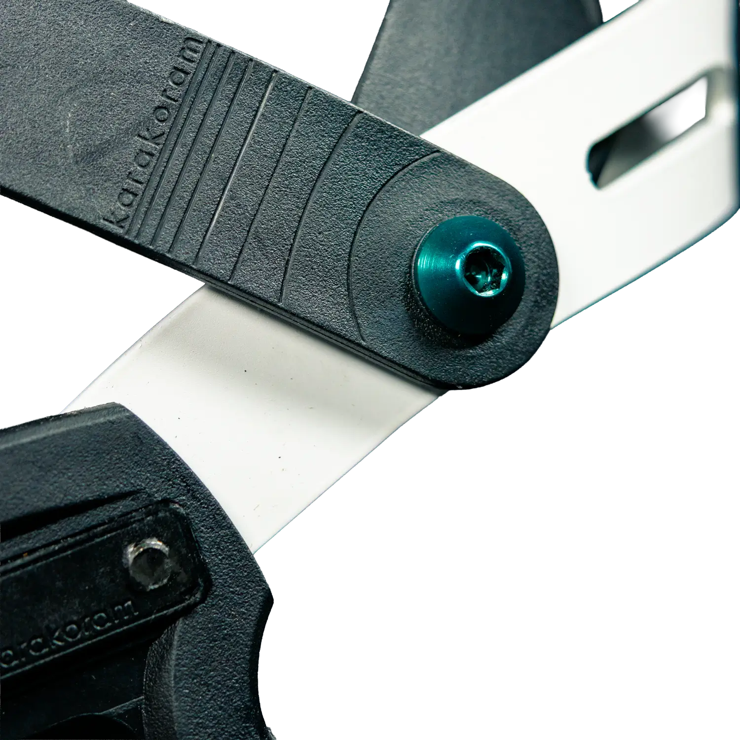 Close-up of black splitboard binding hinge with teal screw