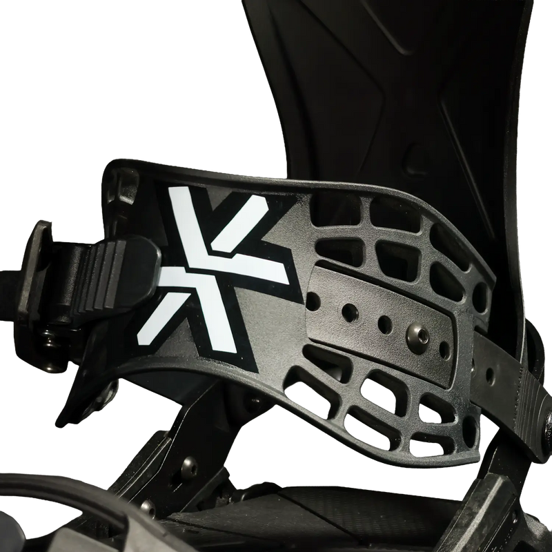 Close-up of black snowboard binding with white X logo and ratchet buckle