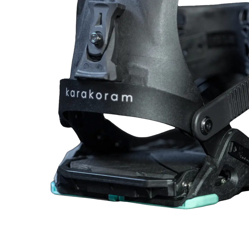 Close-up of black splitboard binding with ankle strap and buckle