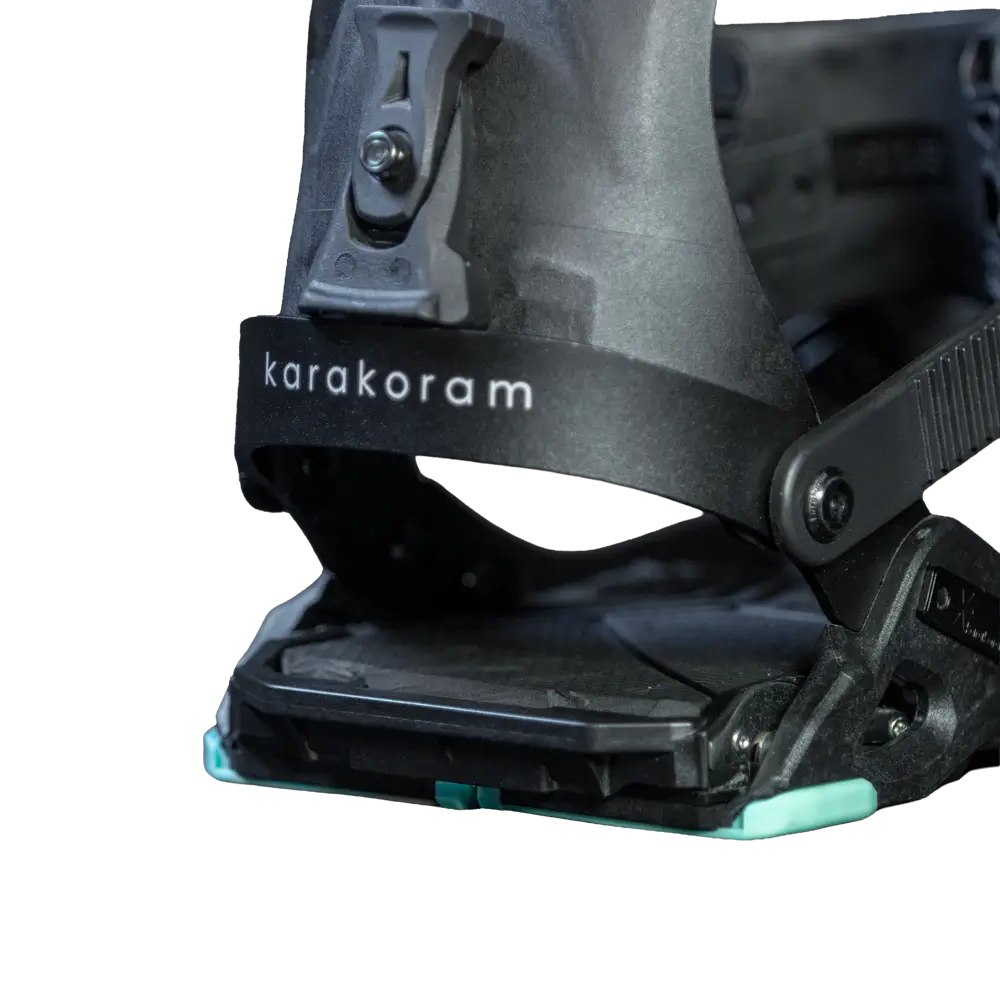 Close-up of black splitboard binding with ankle strap and buckle