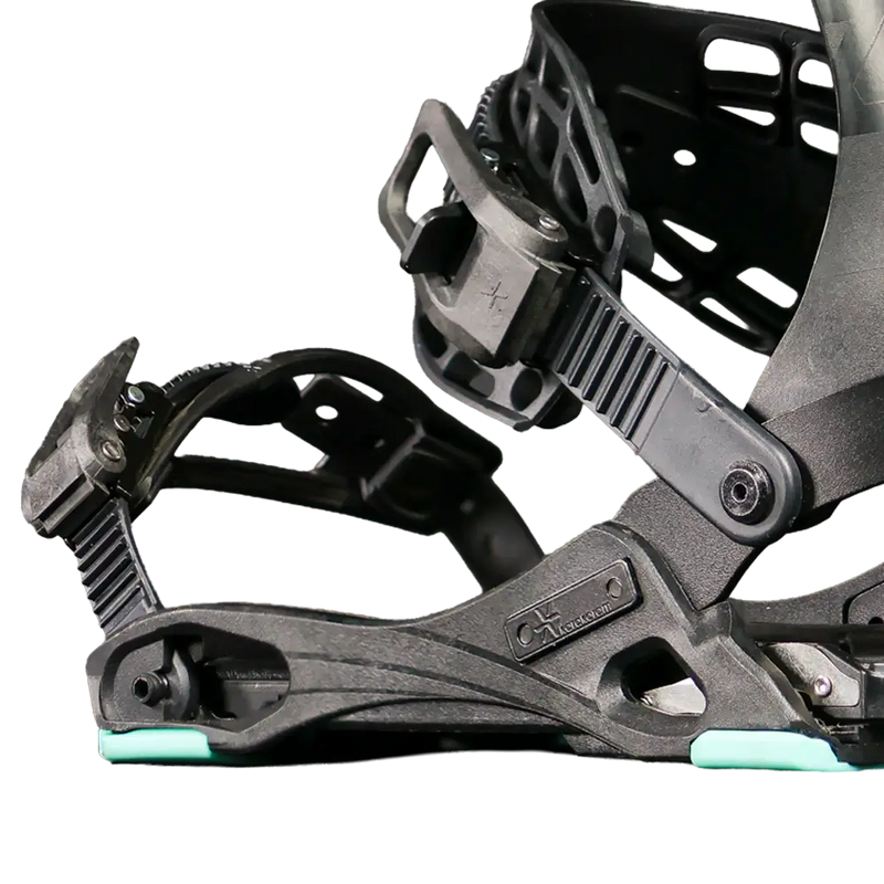 Close-up of black snowboard binding with mint green baseplate accents