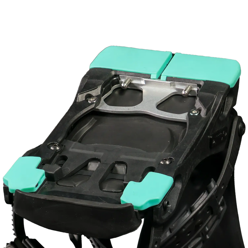 Black ski boot buckle mechanism with teal plastic pads, close-up view