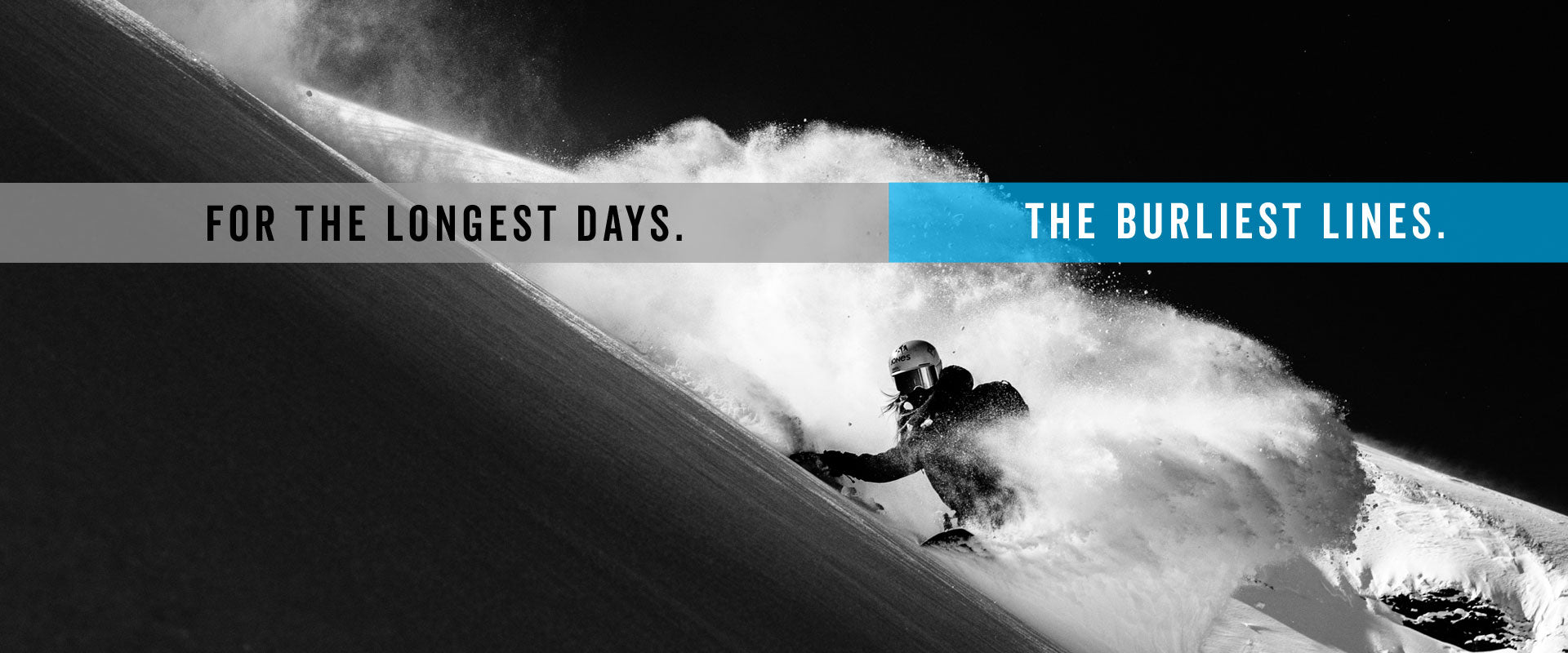 Snowboarder carving steep slope, black-and-white powder spray photo